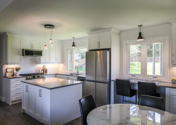 Kitchen Renovation with White Cabientry and Grey Accents. Load Bearing Wall Removal.